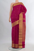 Pure Silk Magenta Kanjivaram Saree with Zari Butta on the body and Zari Border.  displayed on a mannequin