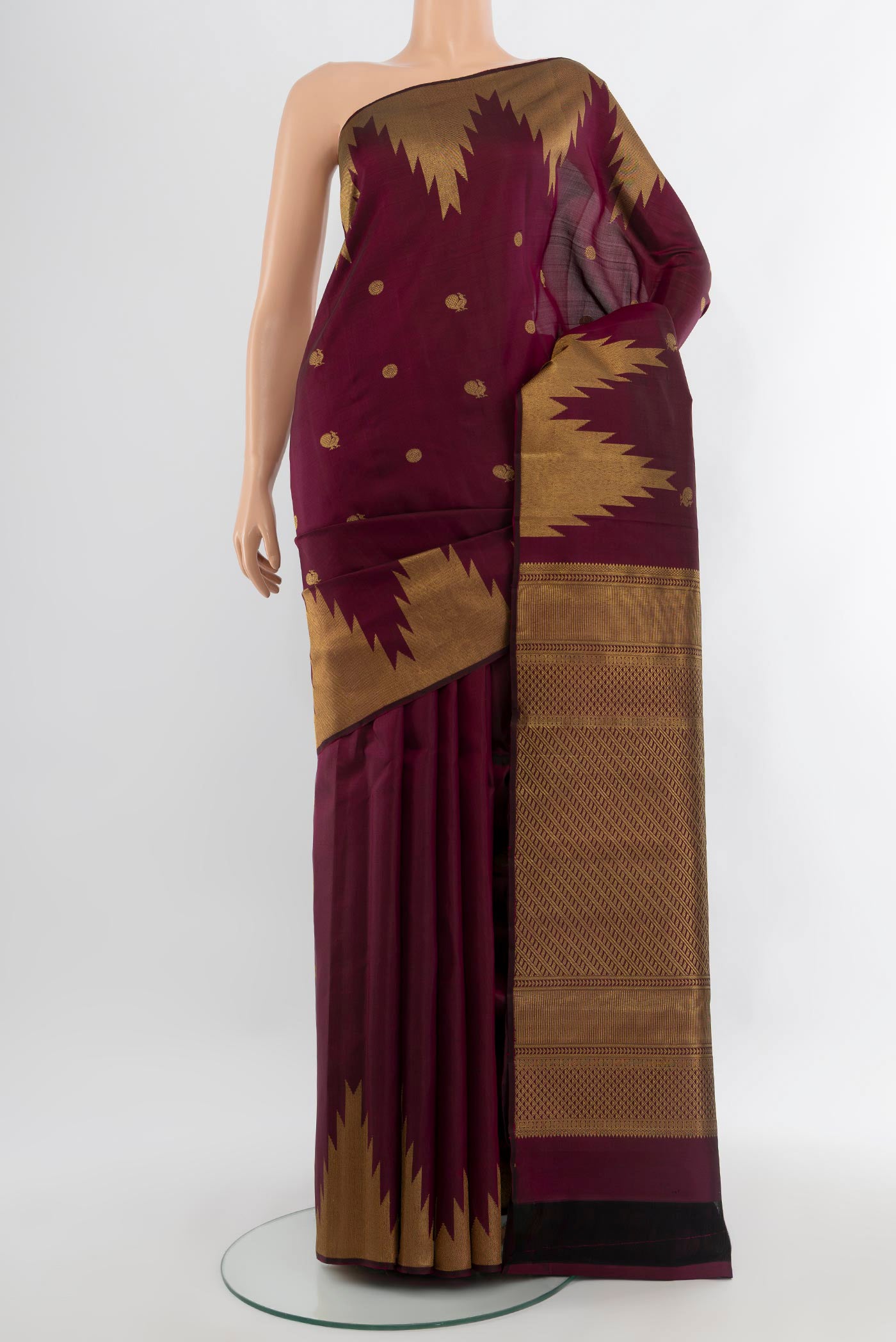 Purple Kanjivaram Silk Saree with Zari Butta on the body and Temple Border.  displayed on a mannequin