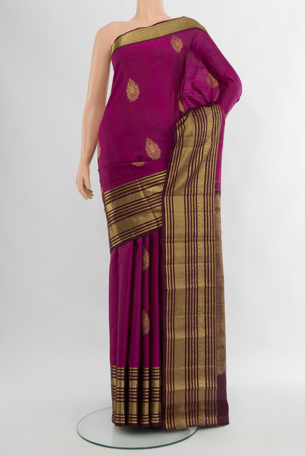 Magenta Kanjivaram Silk Saree with Zari Butta on the body and Zari Border.  displayed on a mannequin