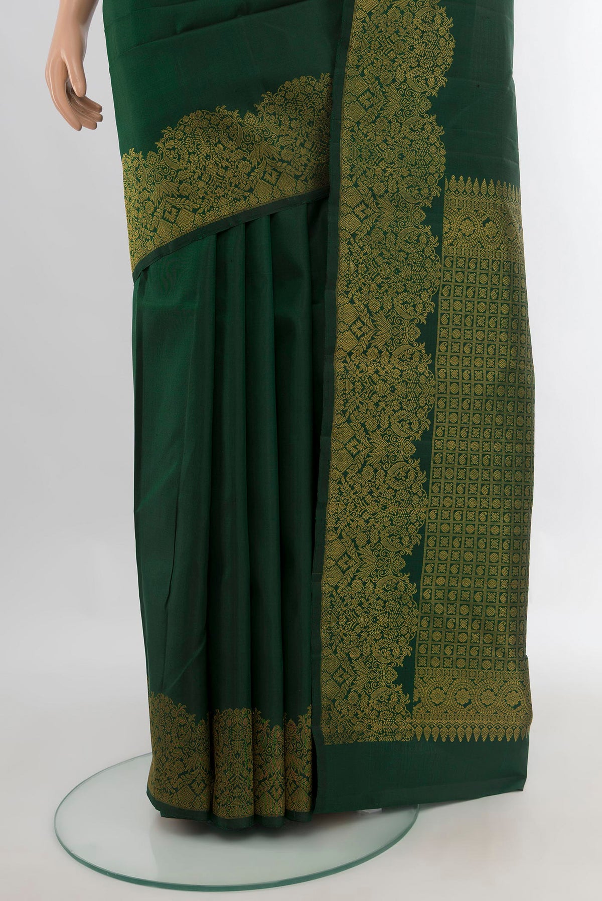 Pleats and pallu of Pure Silk Bottle Green Kanchipuram Saree with Plain Body and Zari Border. 