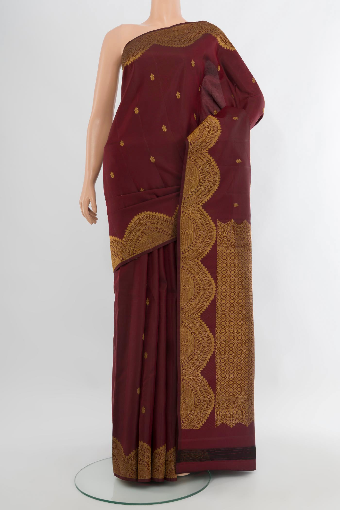 Coffee Brown Kanjivaram Silk Saree with Zari Butta on the body and Zari Border.  displayed on a mannequin