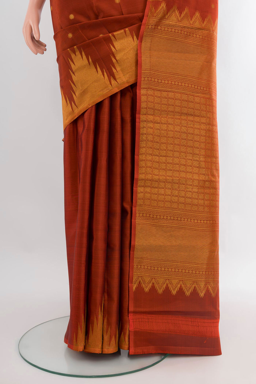 Pleats and pallu of Rust Kanchipuram Silk Saree with Zari Butta on the body and Temple Border. 