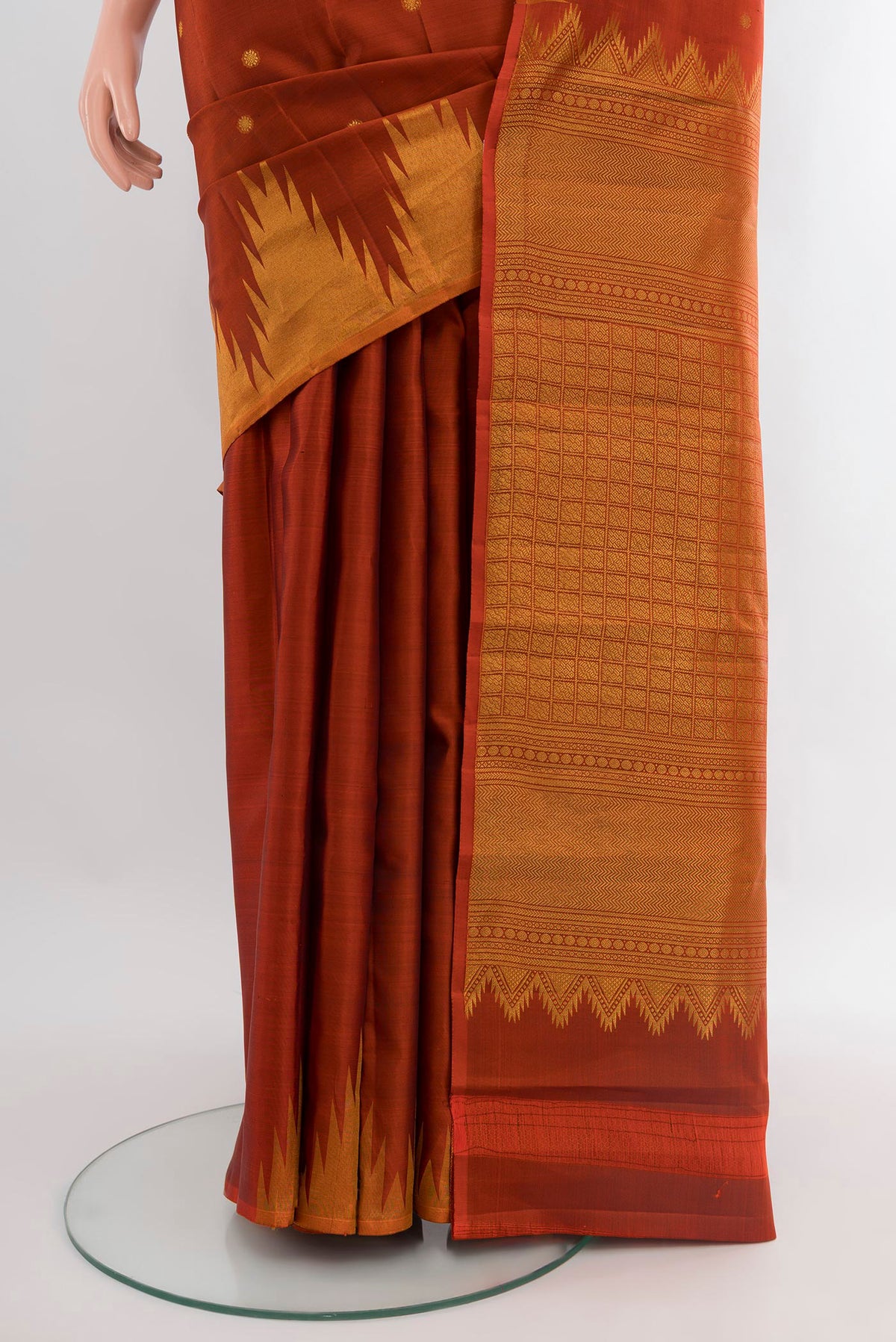 Pleats and pallu of Rust Kanchipuram Silk Saree with Zari Butta on the body and Temple Border. 