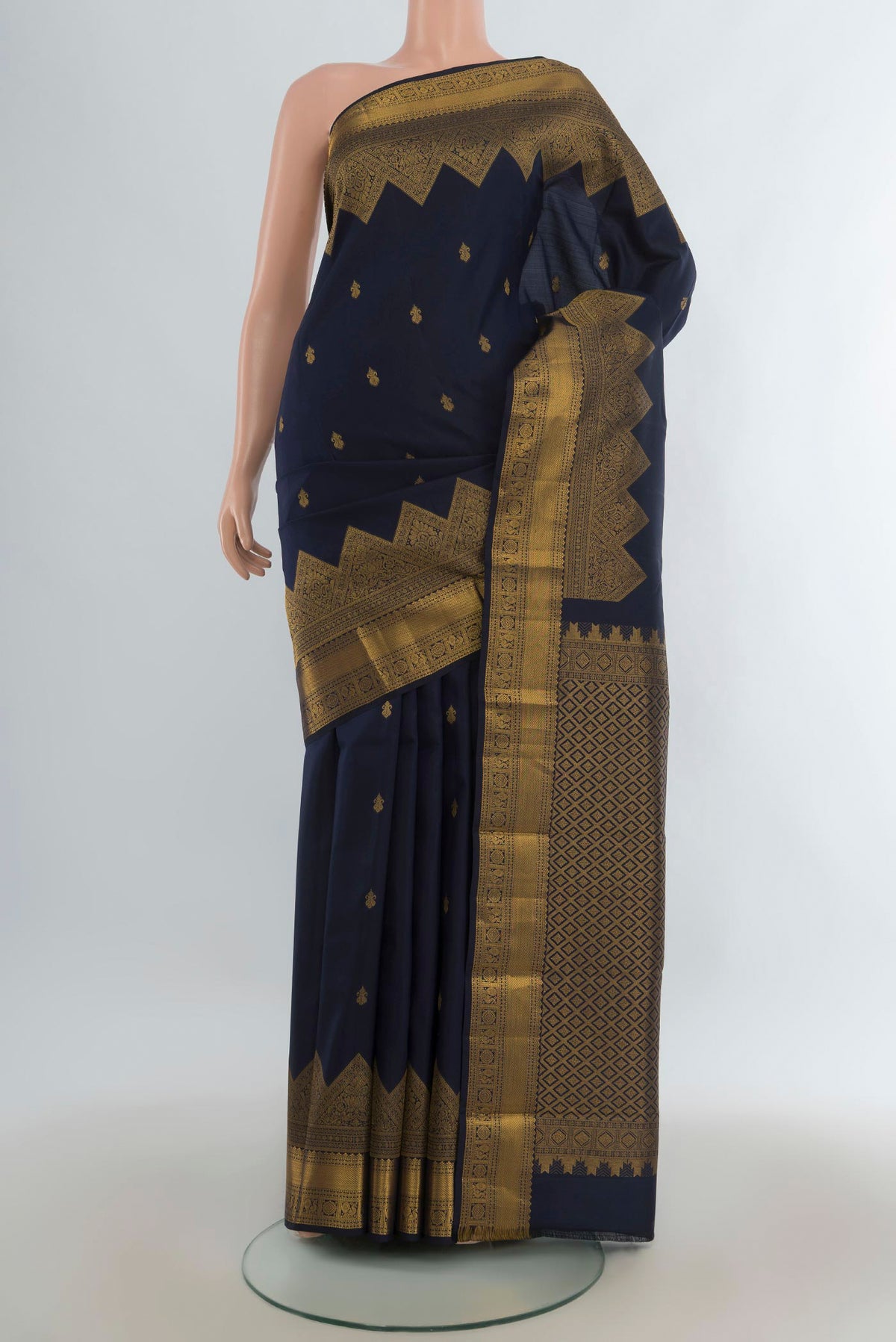 Pure Silk Navy Blue Kanjivaram Saree with Zari Butta on the body and Temple Border.  displayed on a mannequin