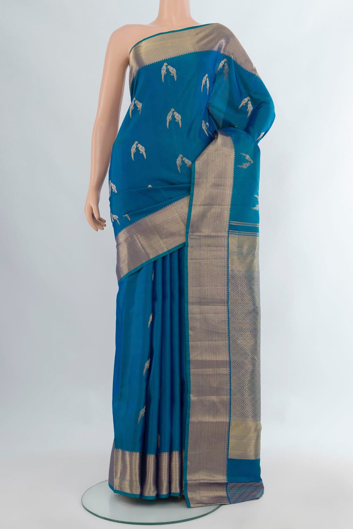 Pure Silk Blue Kanjivaram Saree with Zari Butta on the body and Zari Border.  displayed on a mannequin