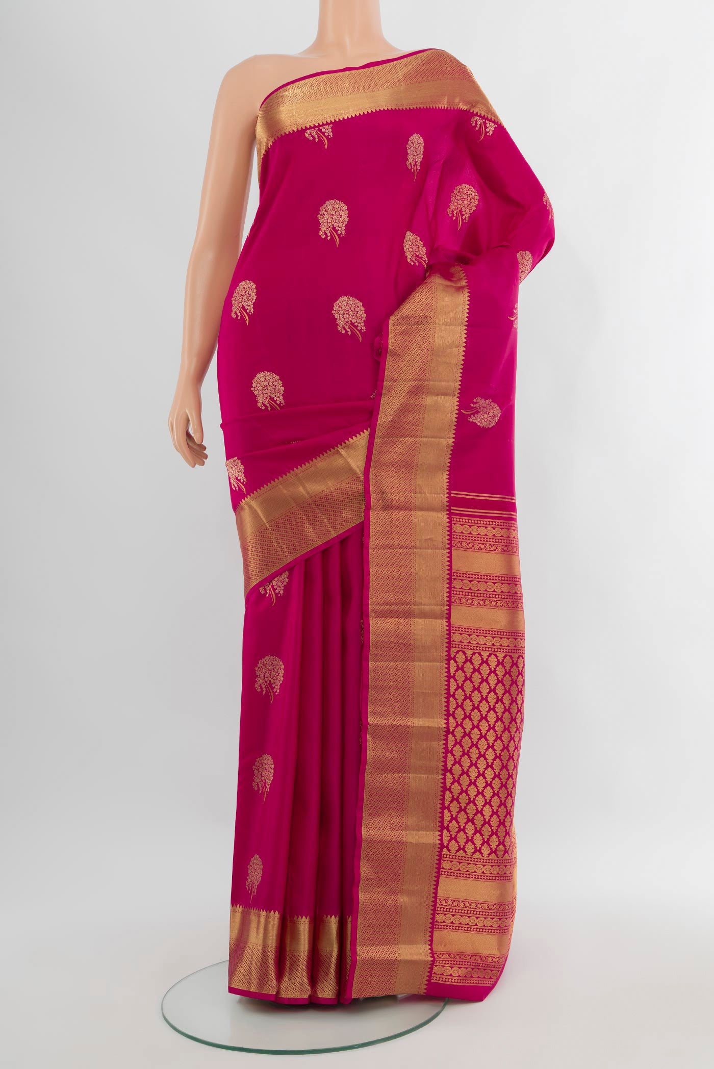 Pink Kanjivaram Silk Saree with Zari Butta on the body and Zari Border.  displayed on a mannequin