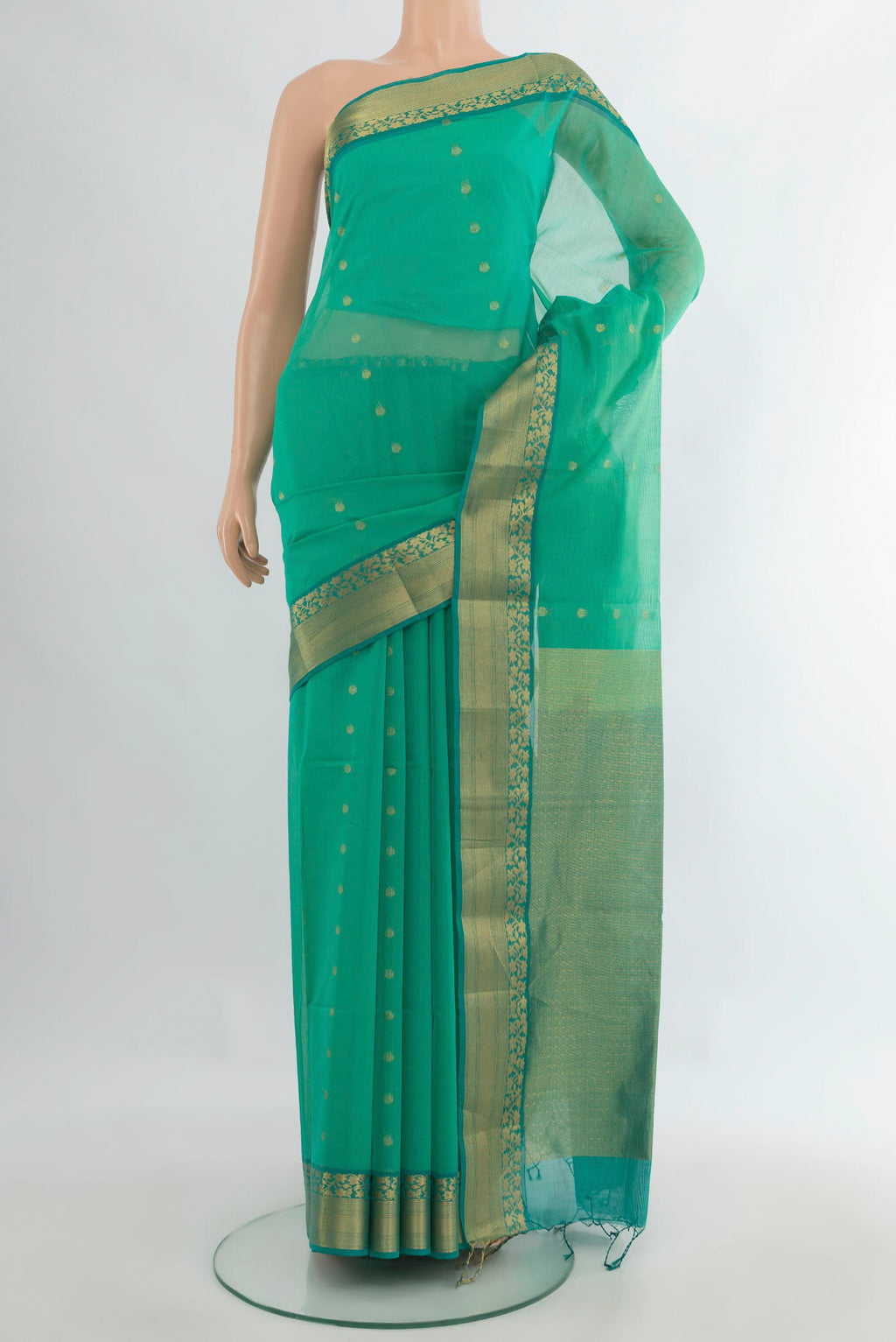 Sea Green Silk Cotton Saree with Zari Butta on the body and Zari Border.  displayed on a mannequin