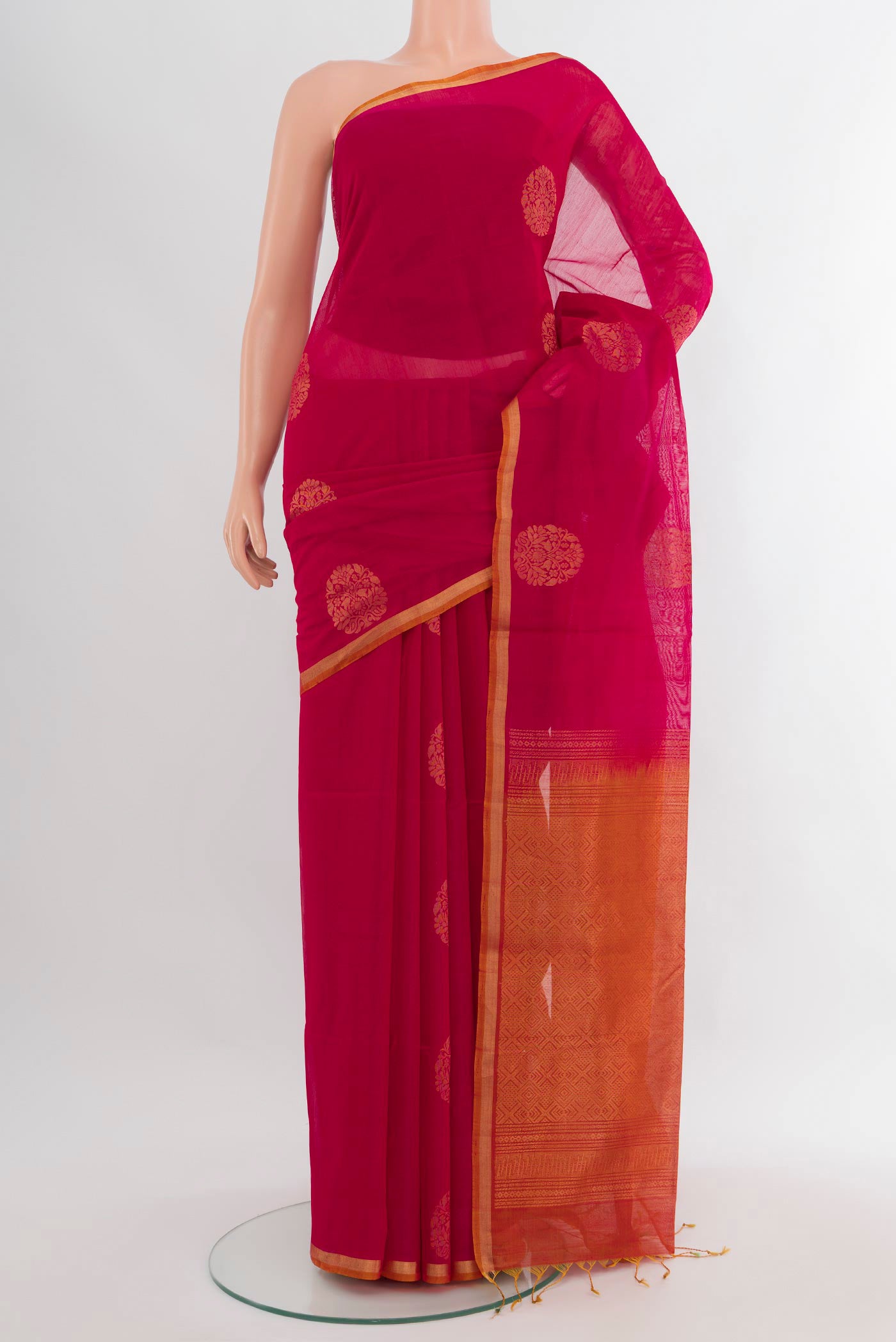 Dark Pink Silk Cotton Saree with Zari Butta on the body and Zari Border.  displayed on a mannequin
