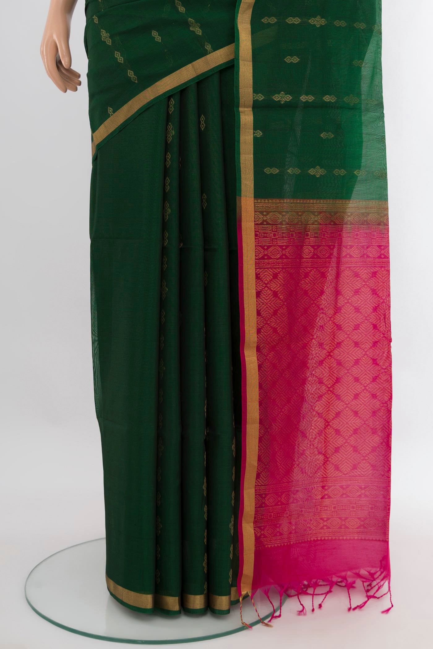 Pleats and pallu of Bottle Green Silk Cotton Saree with Zari Butta on the body and Zari Border. 