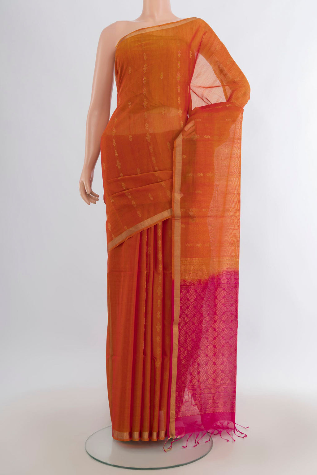 Mustard Silk Cotton Saree with Zari Butta on the body and Zari Border.  displayed on a mannequin