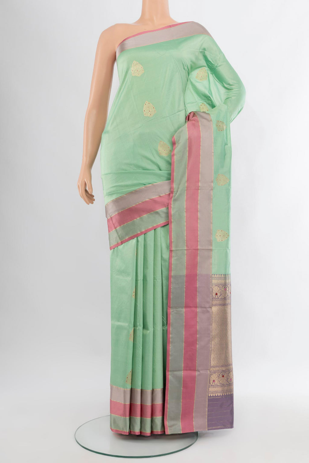 Mint Green Banarasi Katan Silk Saree with Zari Butta on the body and Zari Border.  displayed on a mannequin