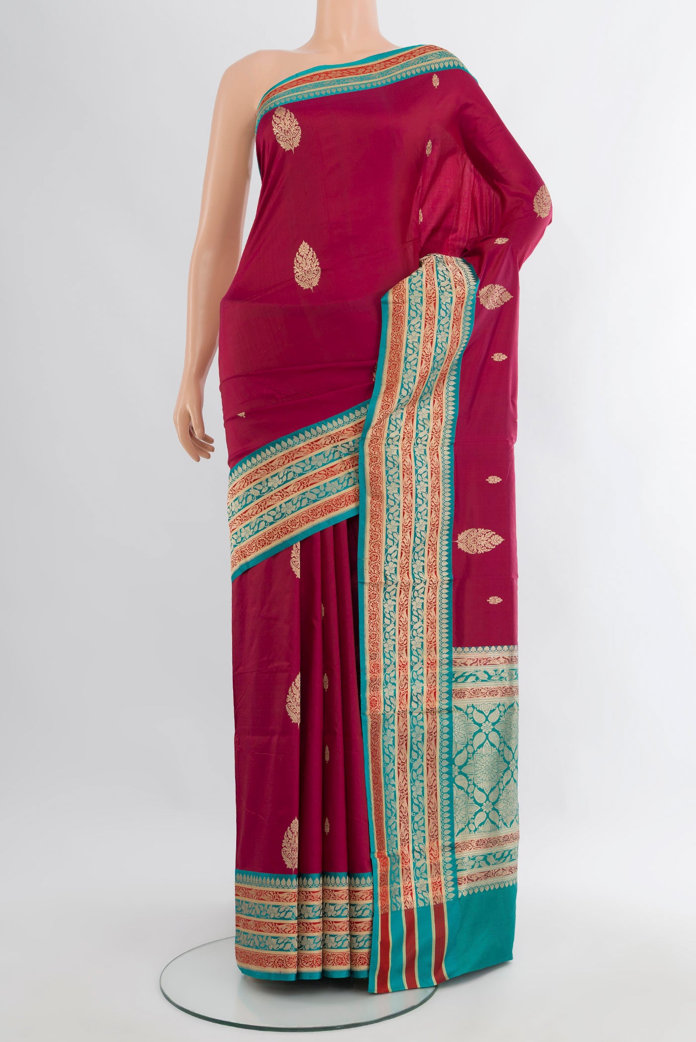 Maroon Banarasi Katan Silk Saree with Zari Butta on the body and Zari Border.  displayed on a mannequin