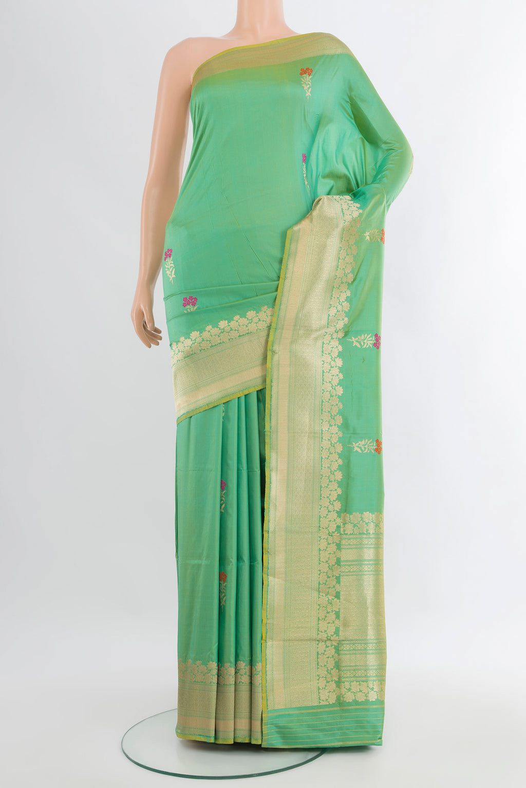 Light Green Banarasi Katan Silk Saree with Zari Butta on the body and Zari Border.  displayed on a mannequin