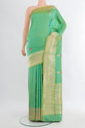 Light Green Banarasi Katan Silk Saree with Zari Butta on the body and Zari Border.  displayed on a mannequin