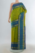 Pure Silk Green Kanjivaram Saree with Zari Butta on the body and Zari Border.  displayed on a mannequin