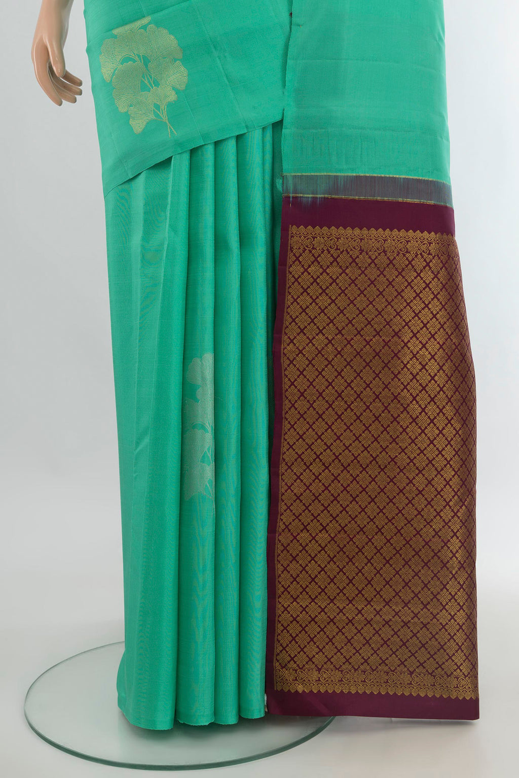 Pleats and pallu of Pure Silk Green Kanjivaram Saree with Zari Butta on the body and Without Border. 