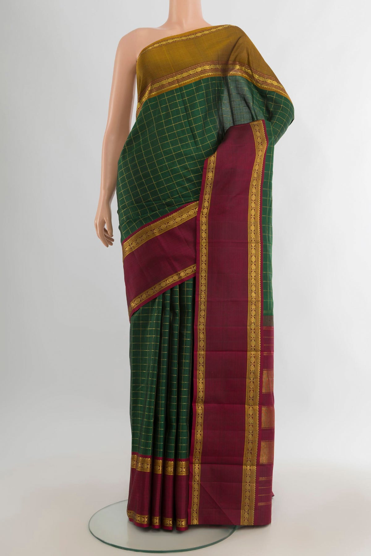 Pure Silk Bottle Green Kanjivaram Saree with Checked design on the body and Ganga Jamuna Border.  displayed on a mannequin