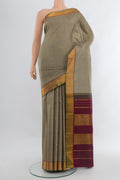 Grey Kanchipuram Silk Saree with Jacquard With Zari Butta on the body and Zari Border.  displayed on a mannequin