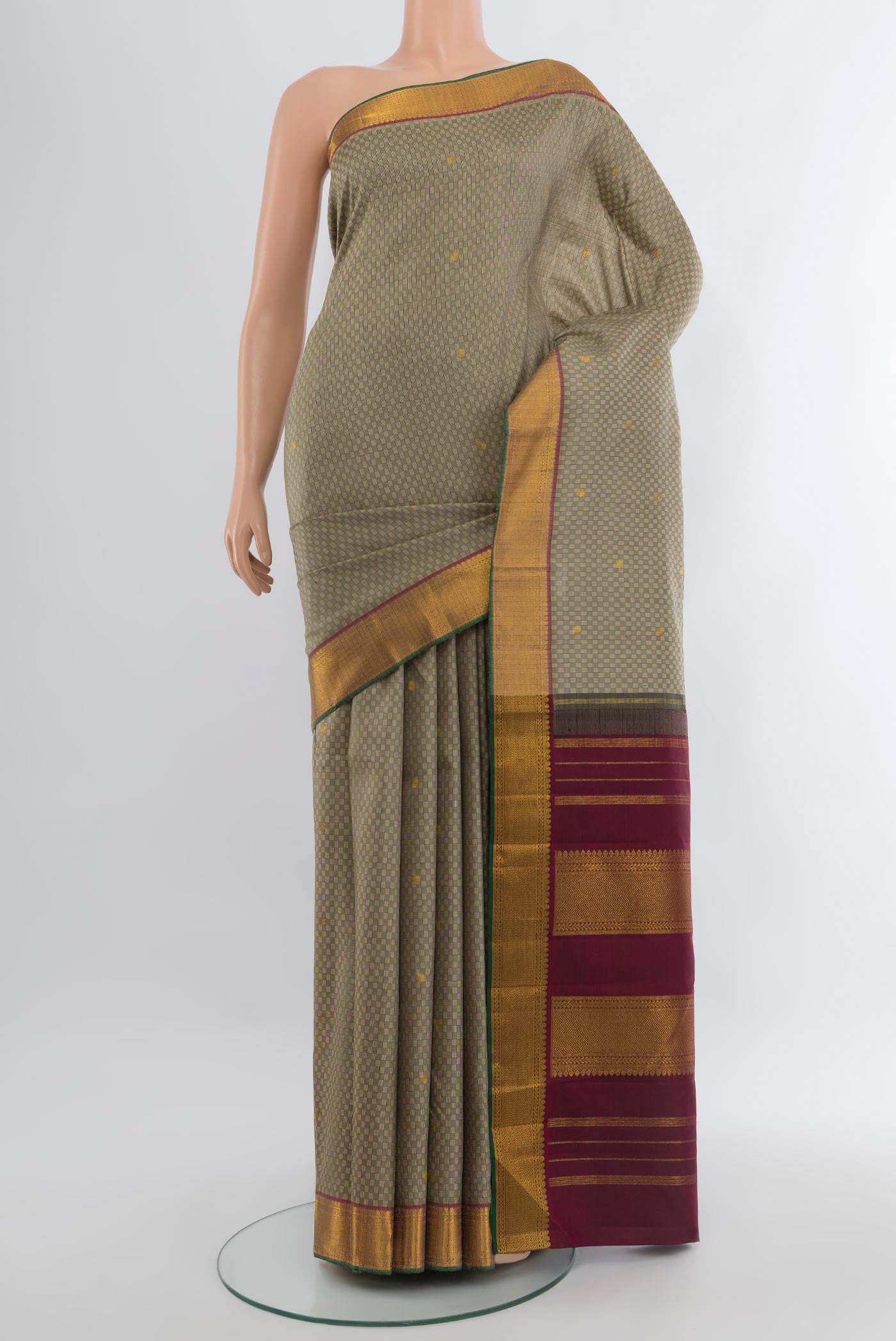 Grey Kanchipuram Silk Saree with Jacquard With Zari Butta on the body and Zari Border.  displayed on a mannequin