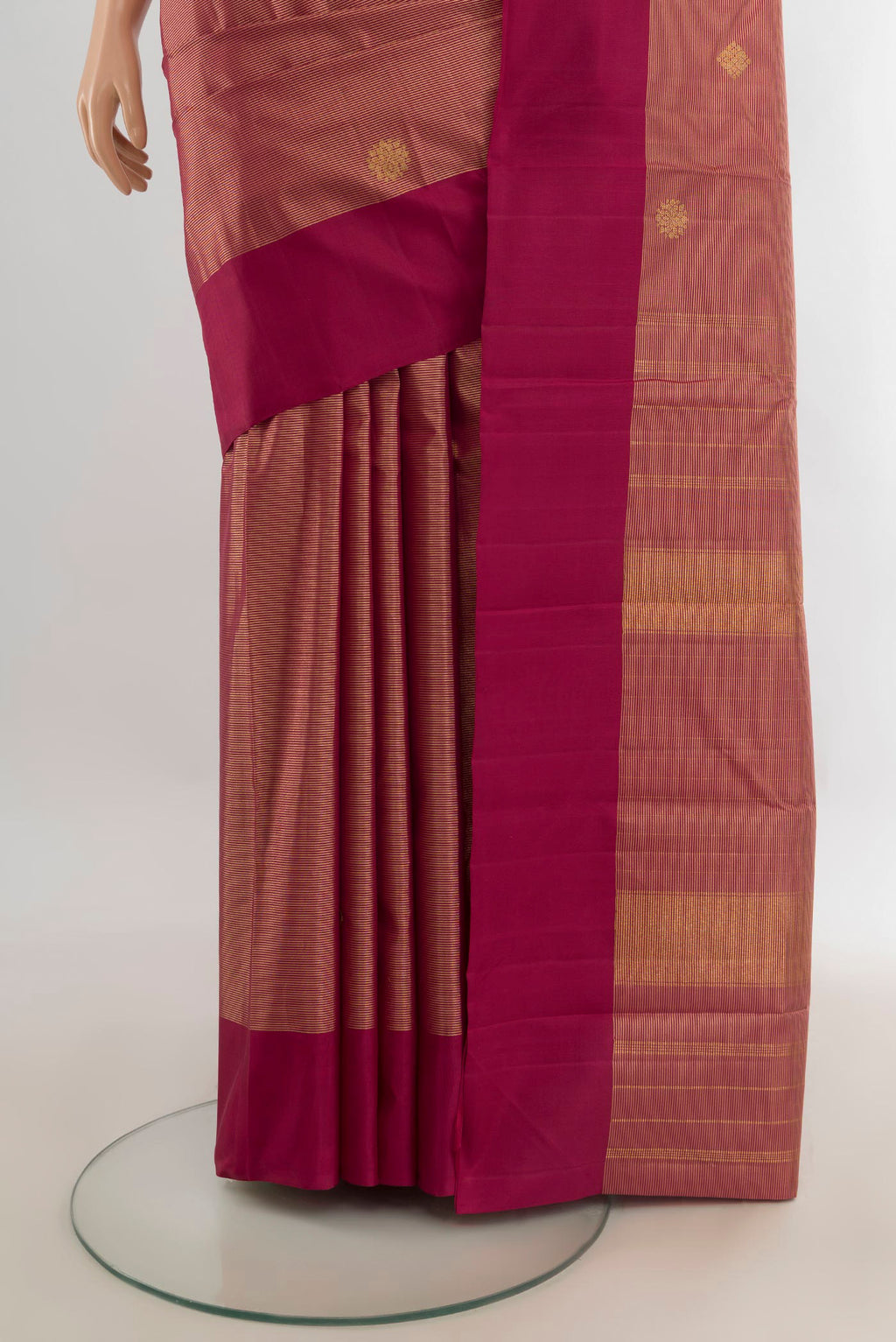 Pleats and pallu of Pure Silk Maroon Kanchipuram Saree with Zari Butta on the body and Plain Border. 