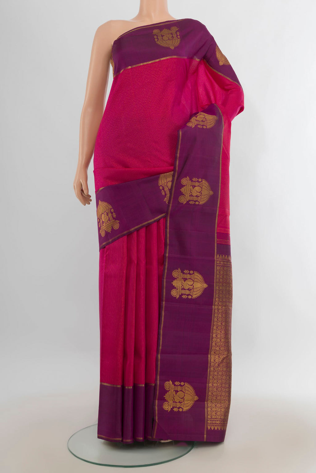 Pure Silk Pure Zari Dark Pink Kanjivaram Saree with Zari Butta on the body and Silk Border.  displayed on a mannequin