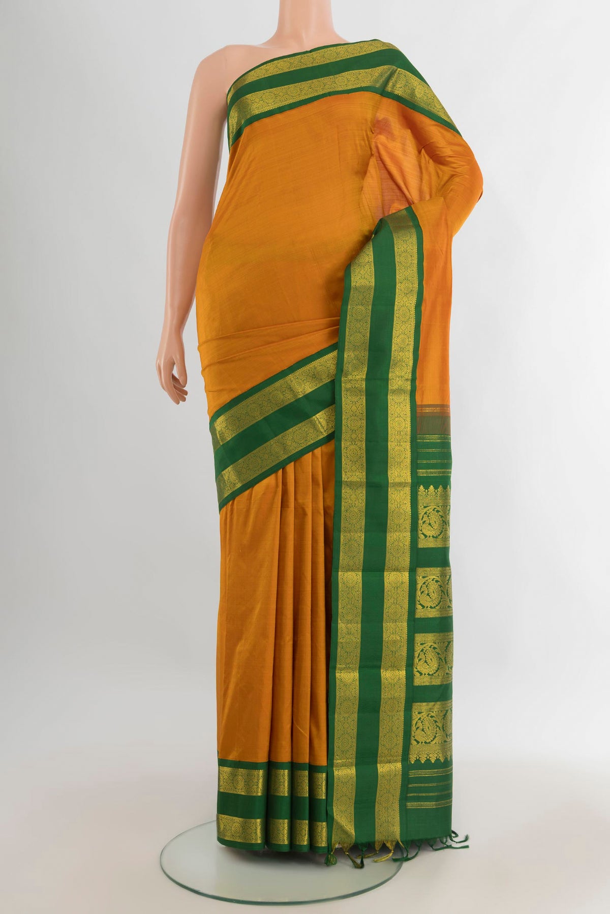 Pure Silk Mustard Kanjivaram Saree with Plain Body and Zari Border.  displayed on a mannequin