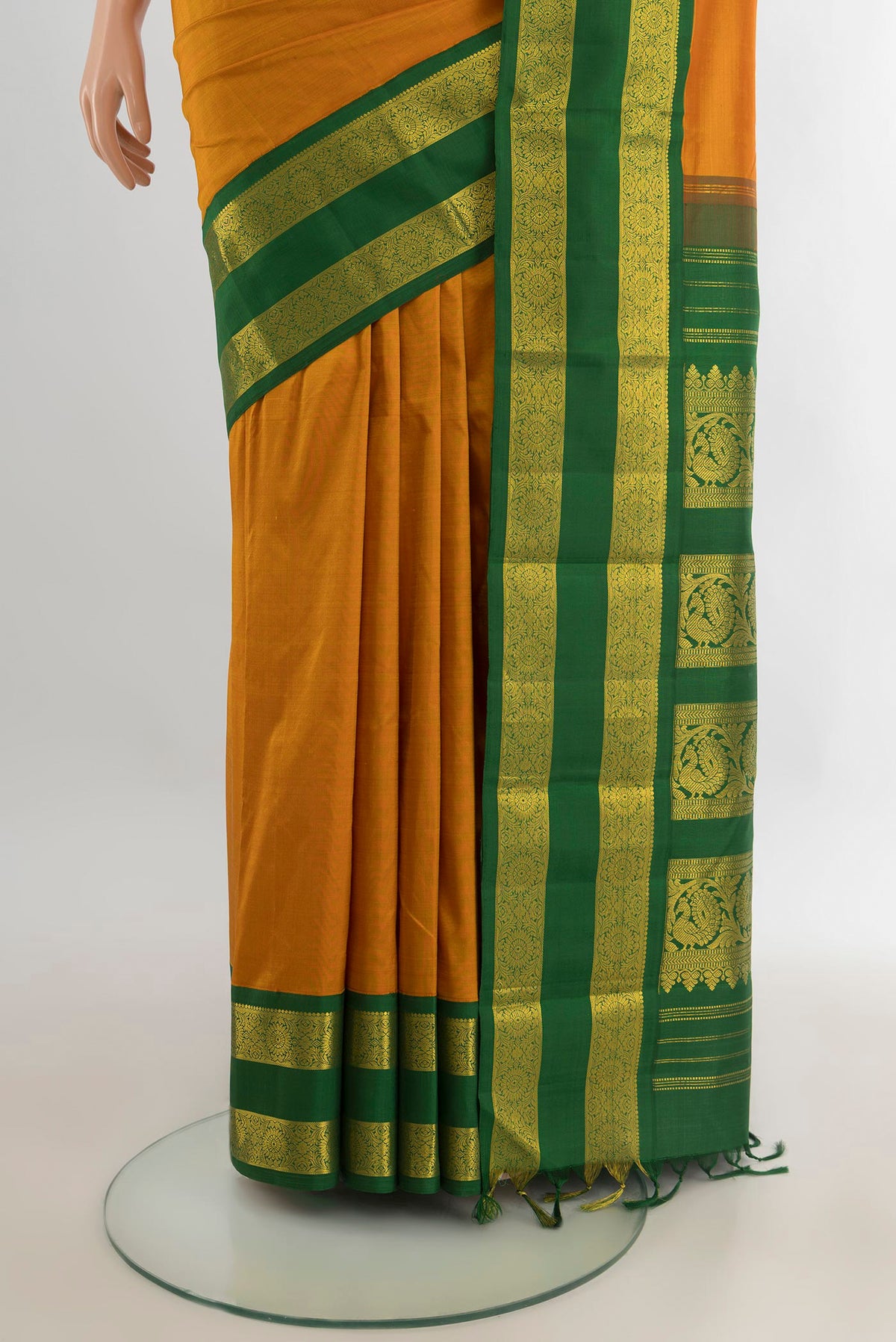 Pleats and pallu of Pure Silk Mustard Kanjivaram Saree with Plain Body and Zari Border. 