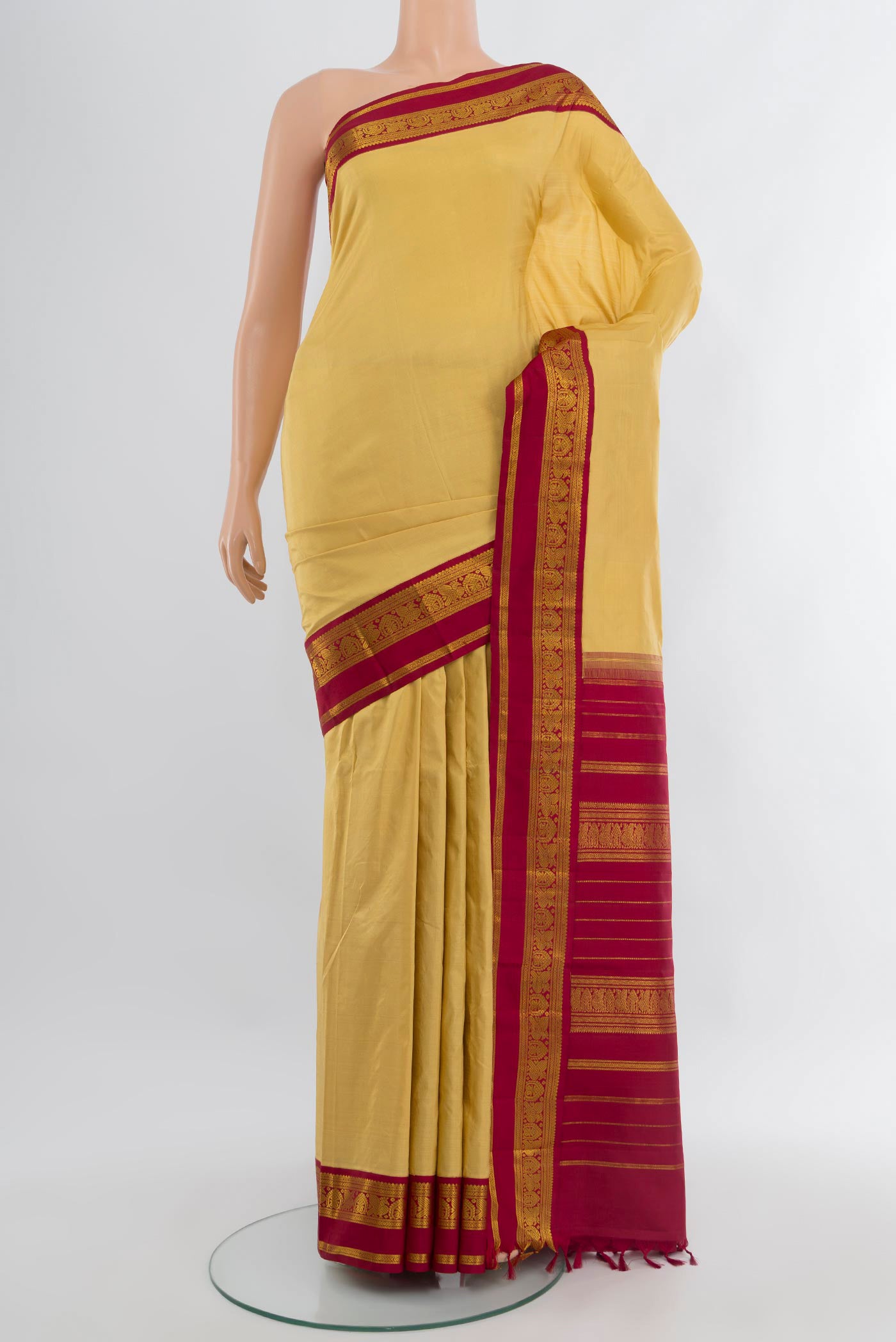 Sandal Kanjivaram Silk Saree with Plain Body and Zari Border.  displayed on a mannequin