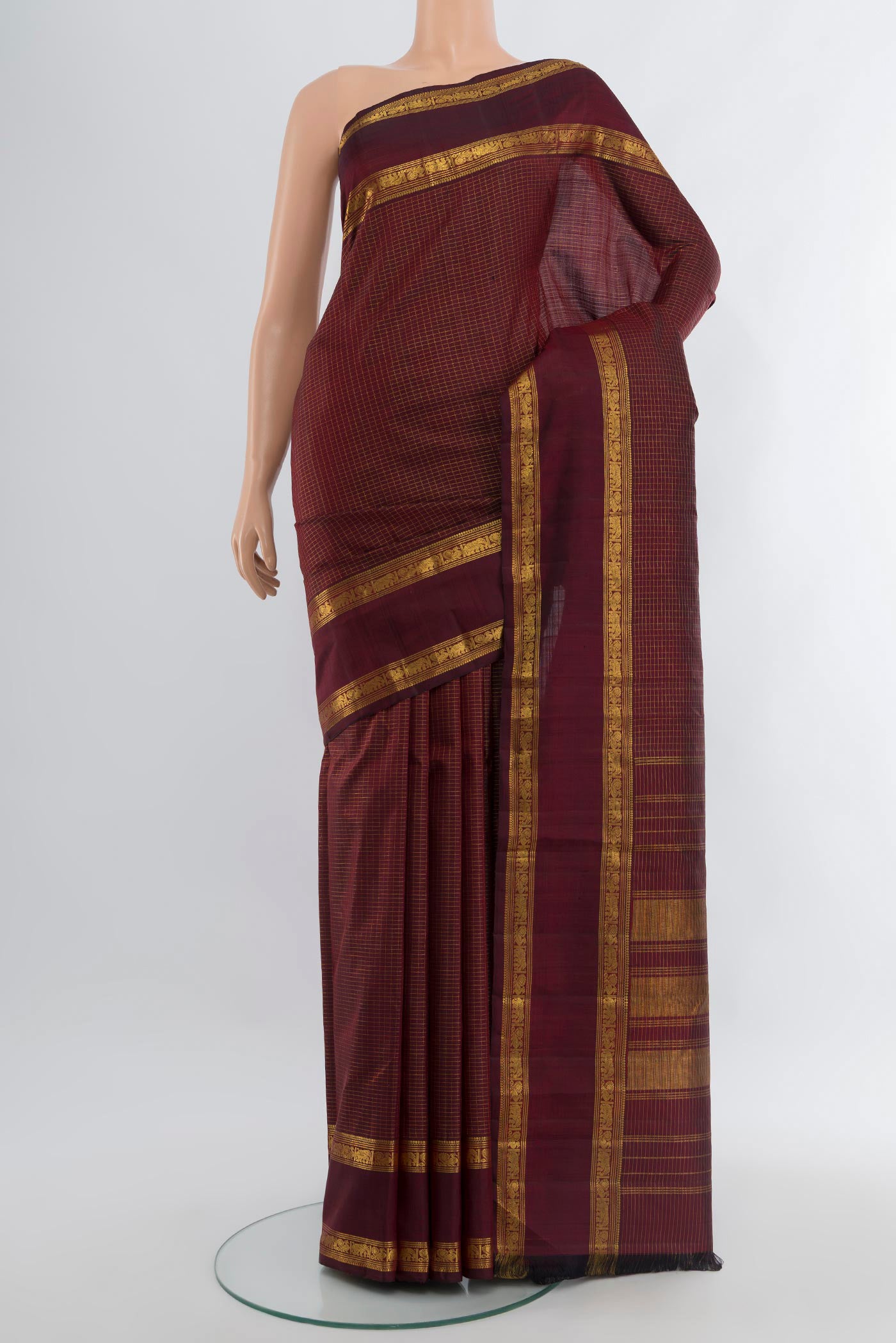 Maroon Kanjivaram Silk Saree with Checked design on the body and Zari Border.  displayed on a mannequin