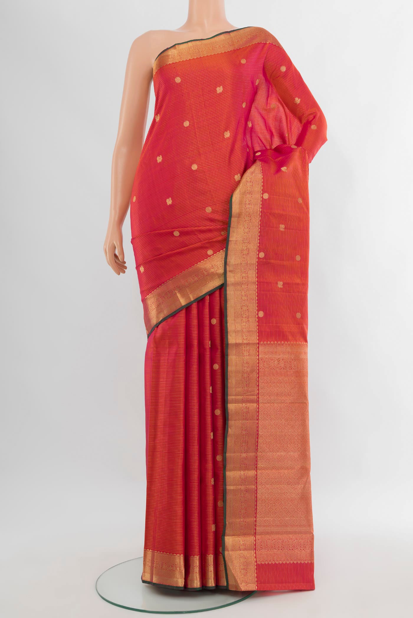 Orange with Pink Color Kanjivaram Silk Saree with Zari Butta on the body and Zari Border.  displayed on a mannequin