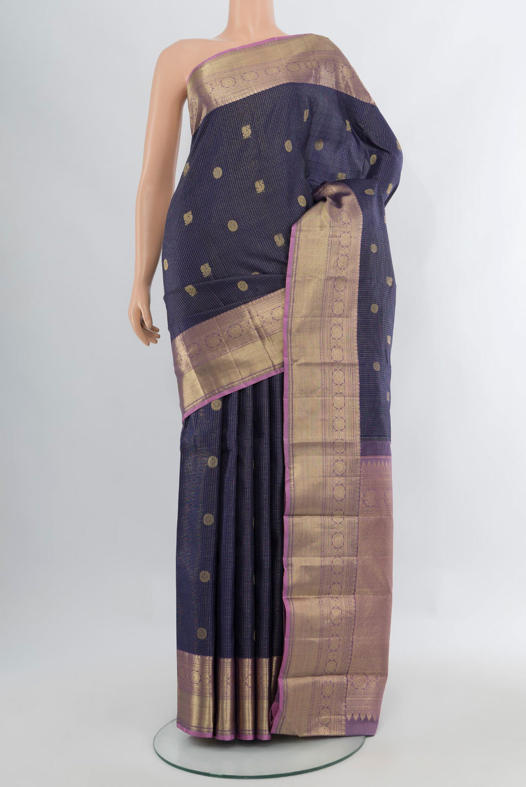 Navy Blue Kanjivaram Silk Saree with Zari Butta on the body and Zari Border.  displayed on a mannequin