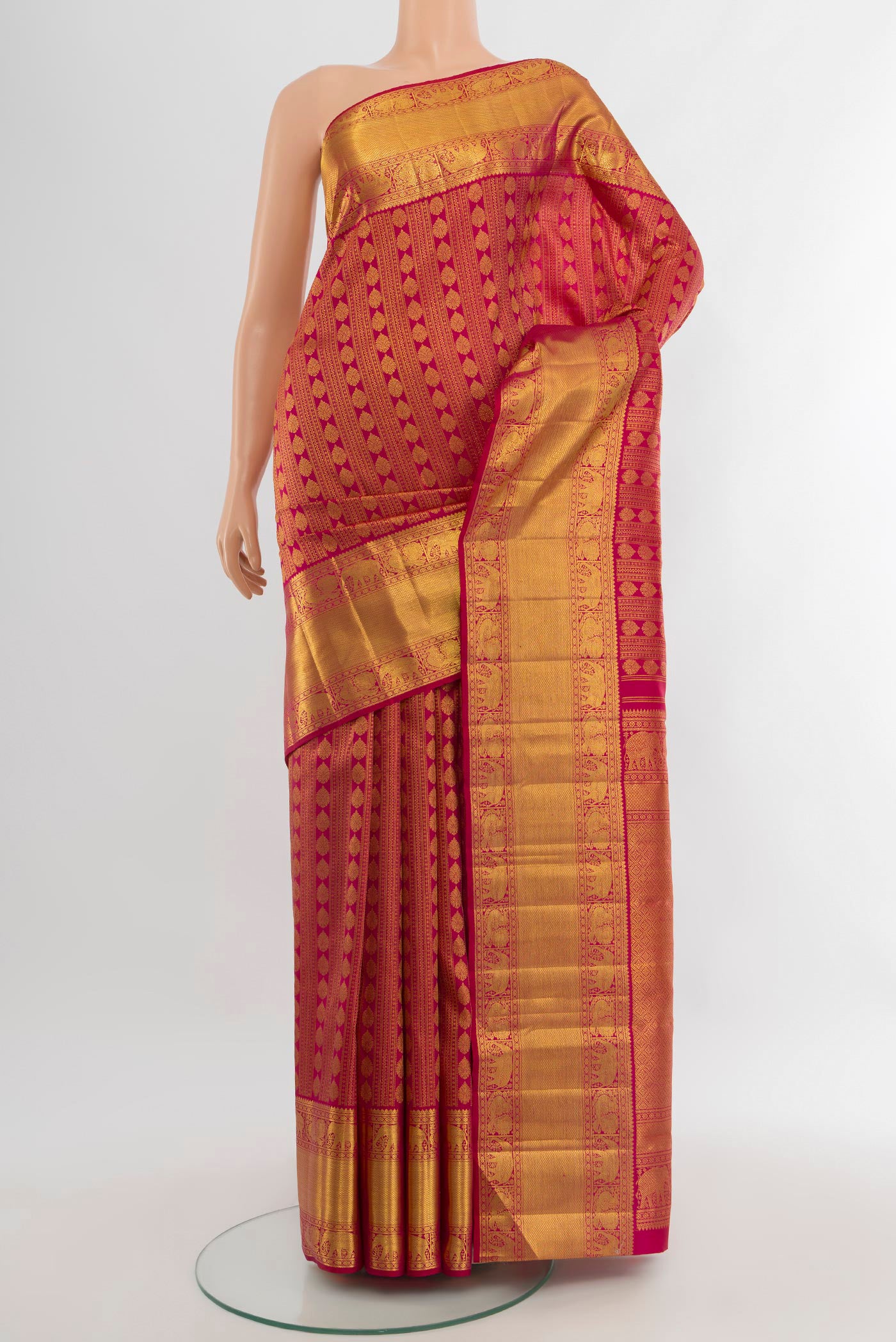 Dark Pink Kanchipuram Silk Saree with Zari Brocade on the body and Zari Border.  displayed on a mannequin