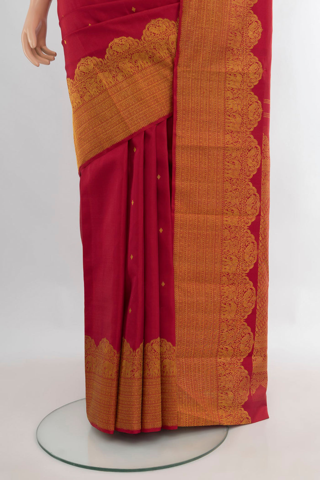 Pleats and pallu of Pure Silk Maroon Kanchipuram Saree with Zari Butta on the body and Fancy Border. 