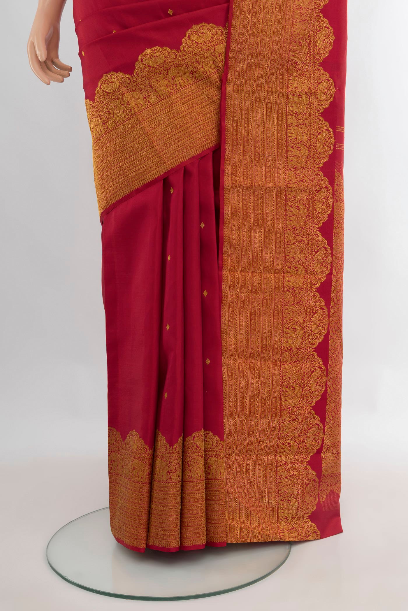 Pleats and pallu of Pure Silk Maroon Kanchipuram Saree with Zari Butta on the body and Fancy Border. 