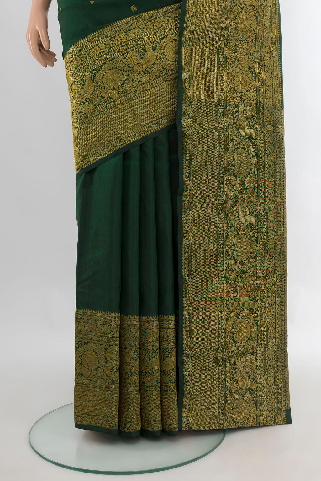 Pleats and pallu of Pure Silk Bottle Green Kanchipuram Saree with Zari Butta on the body and Fancy Border. 