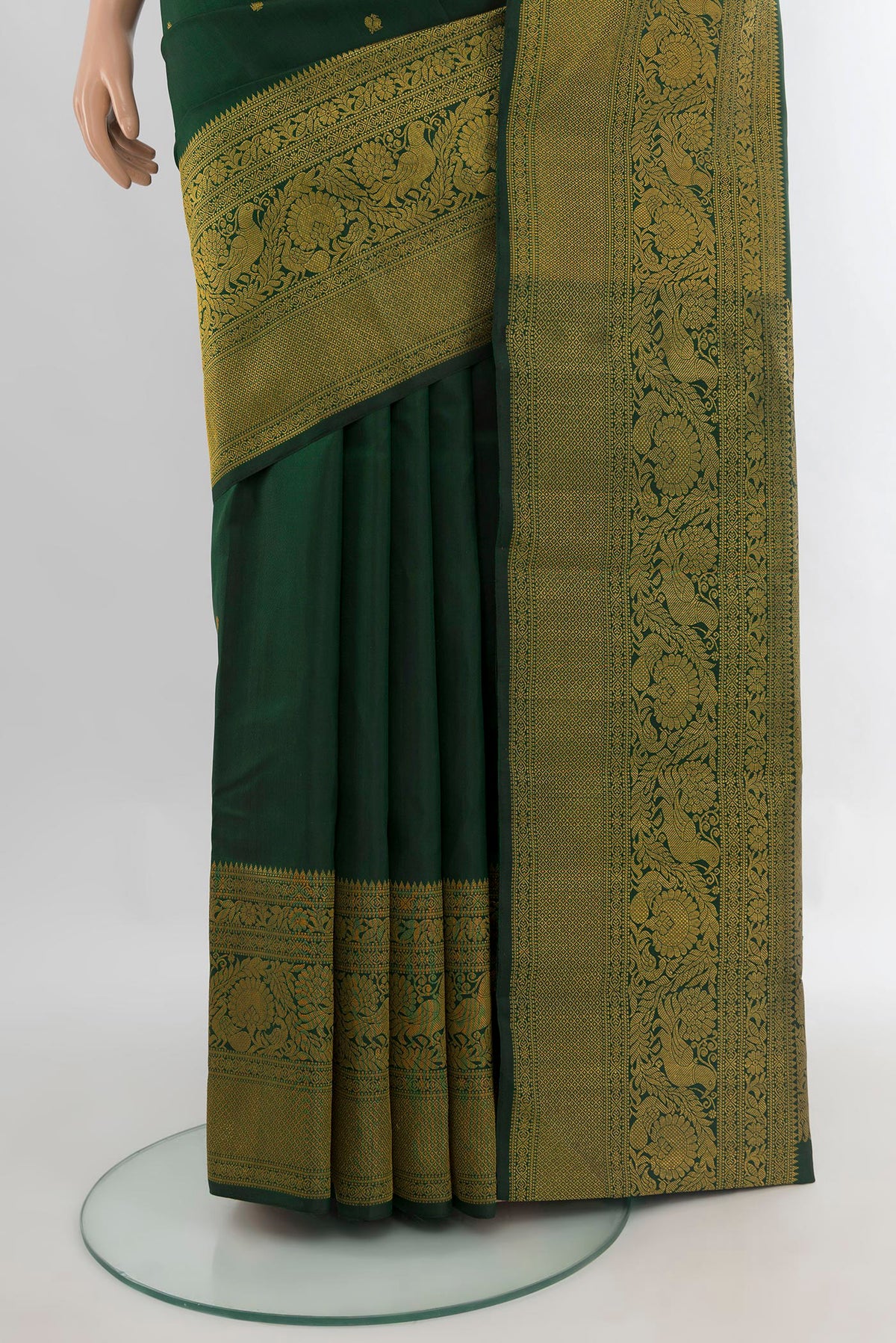 Pleats and pallu of Pure Silk Bottle Green Kanchipuram Saree with Zari Butta on the body and Fancy Border. 