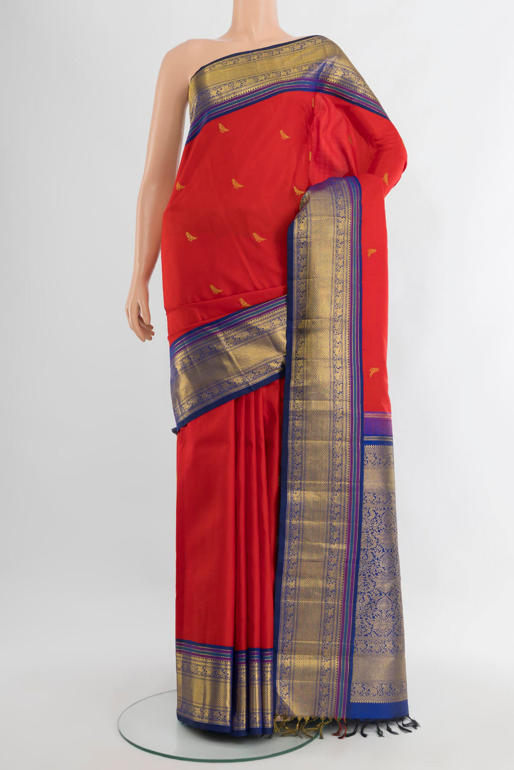 Pure Silk Pure Zari Red Kanchipuram Saree with Zari Butta on the body and Zari Border.  displayed on a mannequin