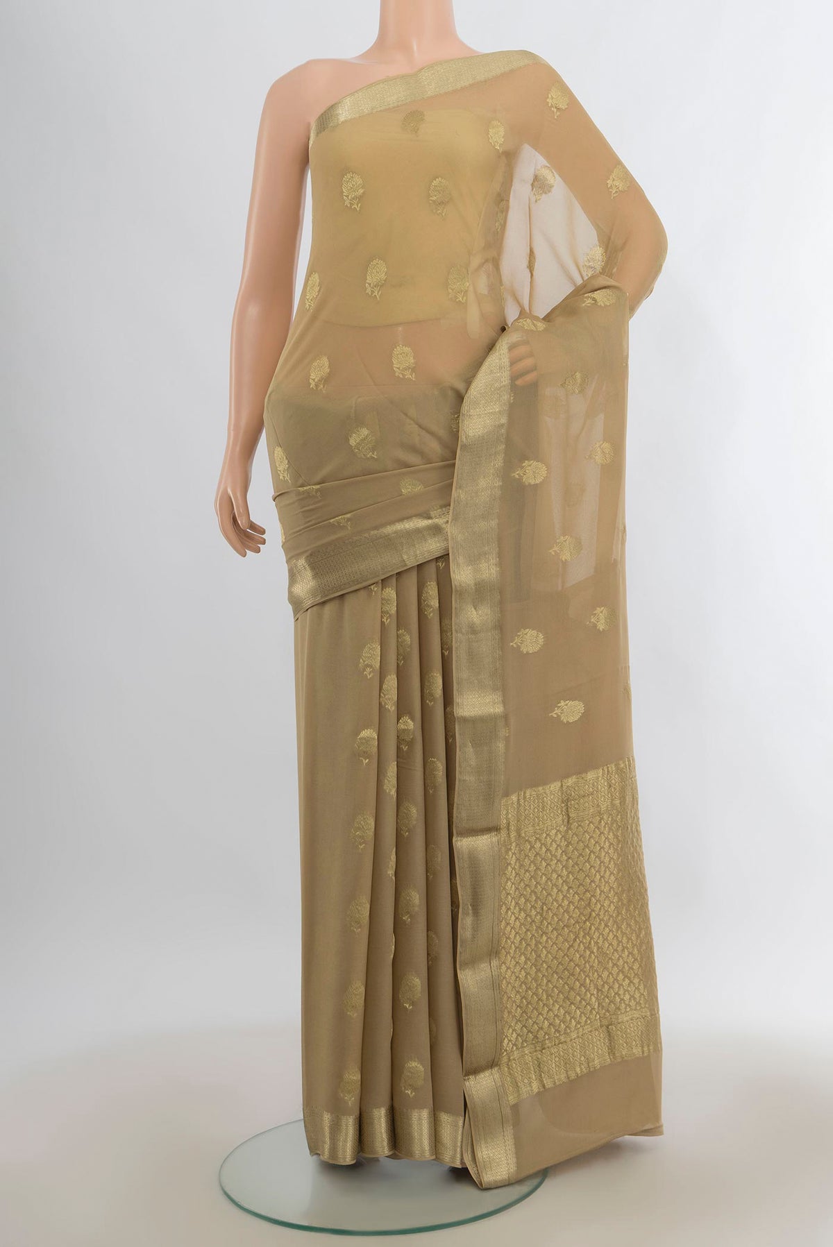 Beige Mysore Georgette Saree with Zari Butta on the body and Zari Border.  displayed on a mannequin