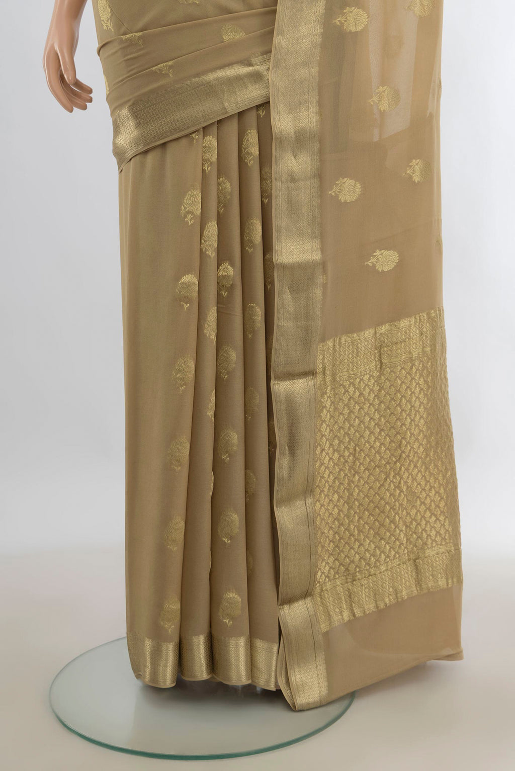 Pleats and pallu of Beige Mysore Georgette Saree with Zari Butta on the body and Zari Border. 