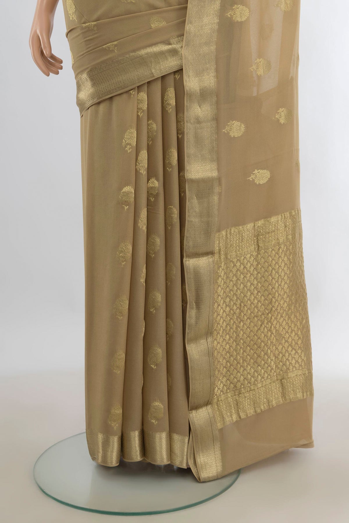 Pleats and pallu of Beige Mysore Georgette Saree with Zari Butta on the body and Zari Border. 