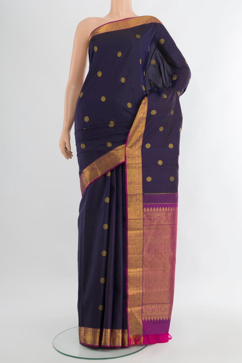 Navy Blue Kanjivaram Silk Saree with Zari Butta on the body and Zari Border.  displayed on a mannequin