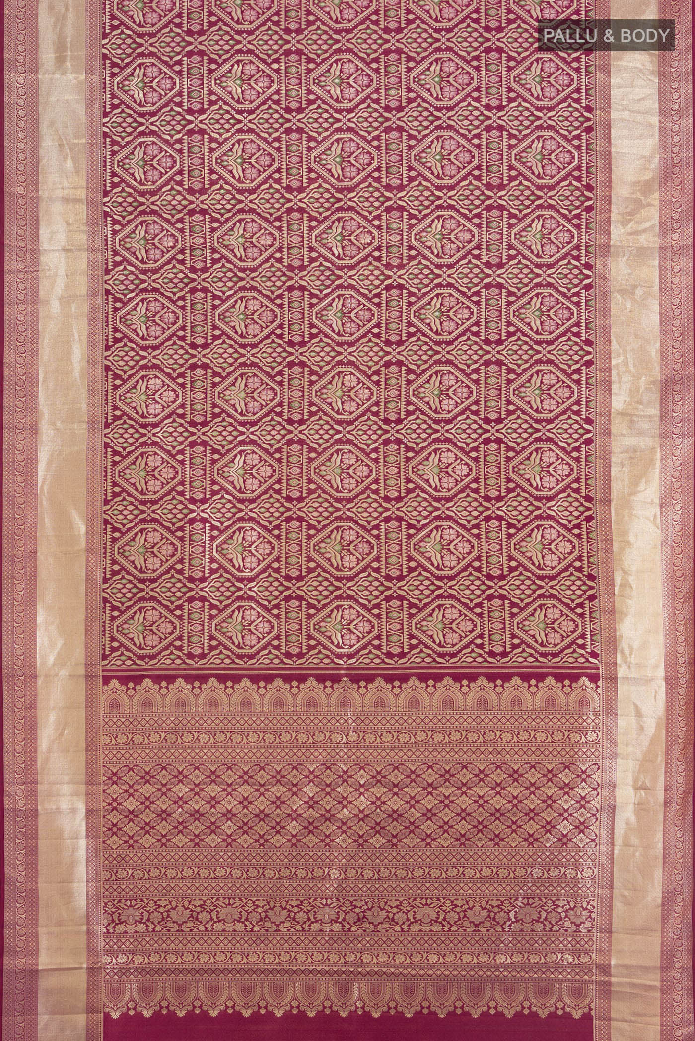 Flat view of Maroon Kanchipuram Tissue Silk Saree with Zari Brocade on the body and Zari Border. 