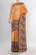 Mustard Kanchipuram Tissue Silk Saree with Zari Brocade on the body and Fancy Border.  displayed on a mannequin