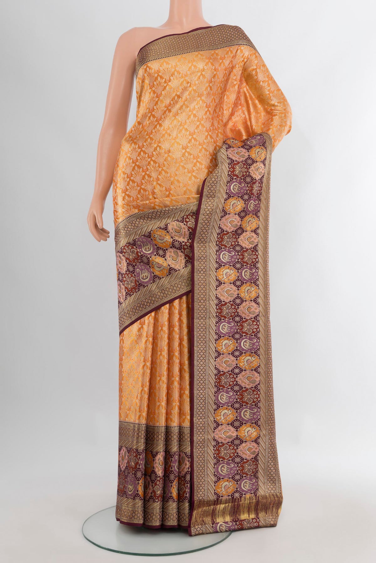 Mustard Kanchipuram Tissue Silk Saree with Zari Brocade on the body and Fancy Border.  displayed on a mannequin