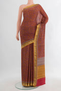 Coral Crepe Saree with Printed design on the body and Zari Border.  displayed on a mannequin