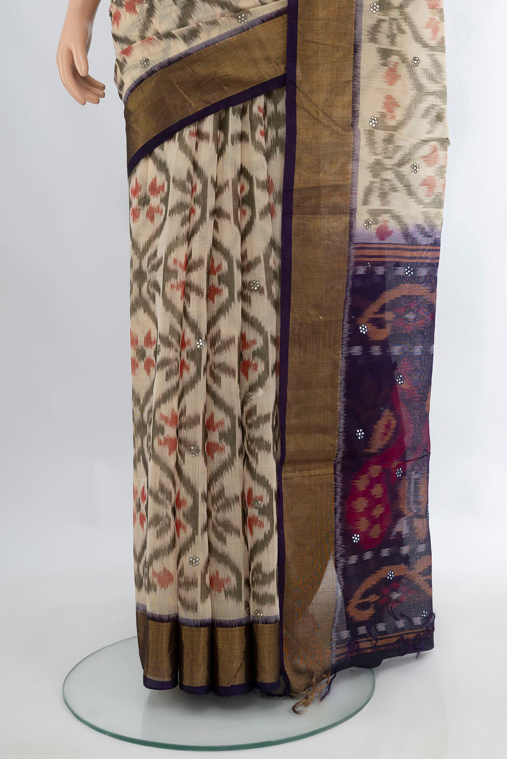 Pleats and pallu of Cream Silk Cotton Saree with Ikat Print on the body and Zari Border. 