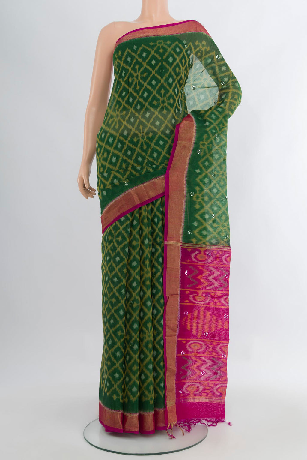 Bottle Green Silk Cotton Saree with Ikat design on the body and Zari Border.  displayed on a mannequin