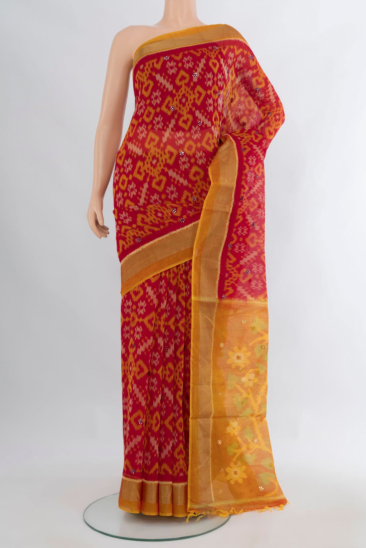Maroon Silk Cotton Saree with Ikat Print on the body and Zari Border.  displayed on a mannequin