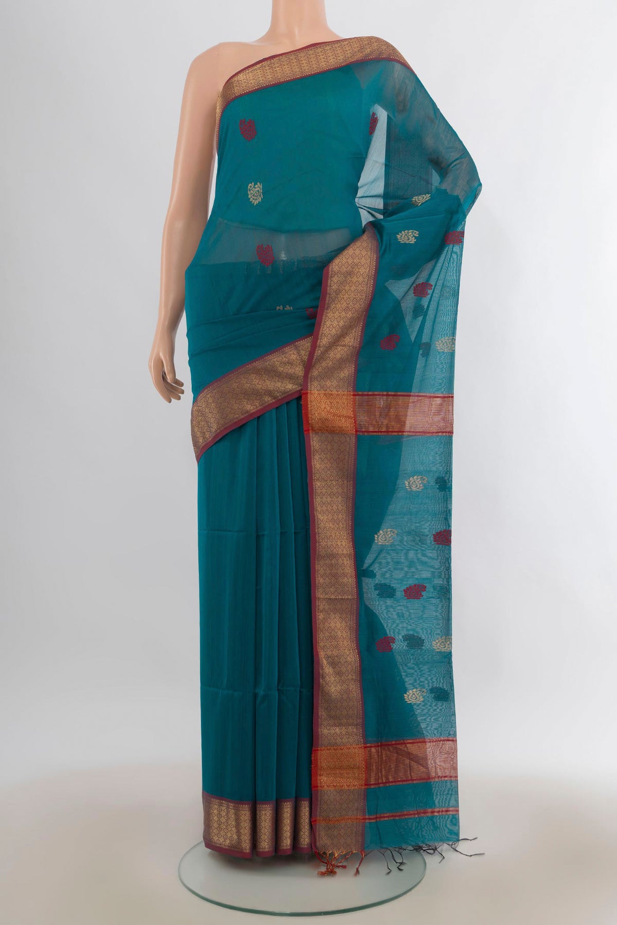 Peacock Blue Maheshwari Cotton Saree with Thread Butta on the body and Zari Border.  displayed on a mannequin
