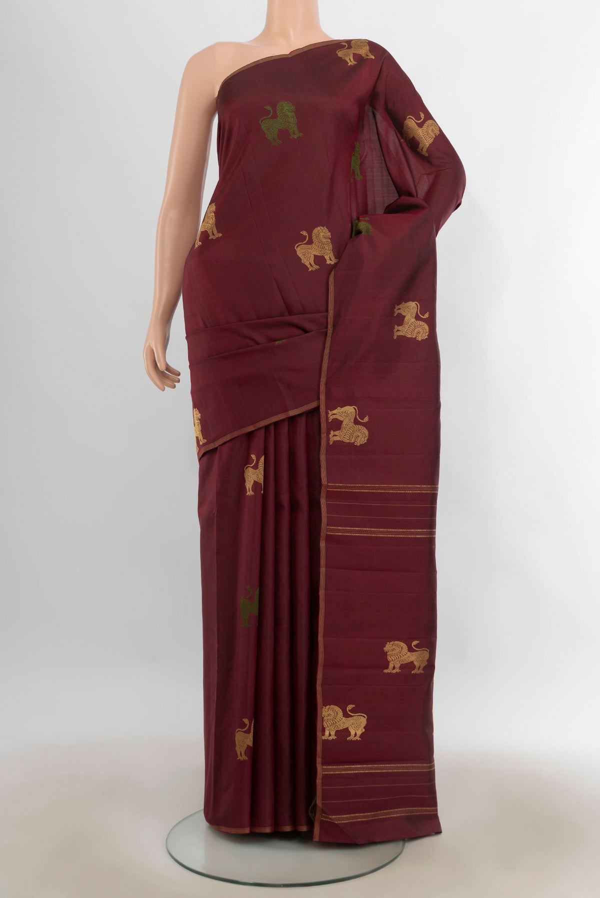 Pure Silk Maroon Kanjivaram Saree with Thread Butta on the body and Thin Zari Line.  displayed on a mannequin